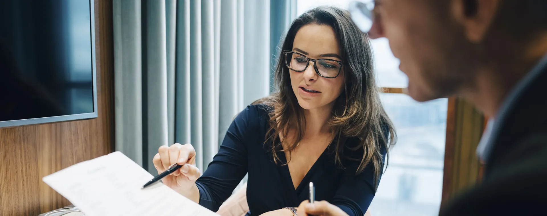 Two people meeting and interacting with documents