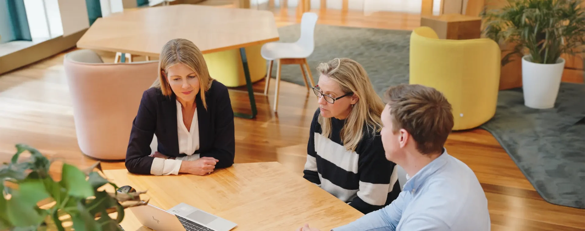 Planning team in a meeting with online participants on the laptop