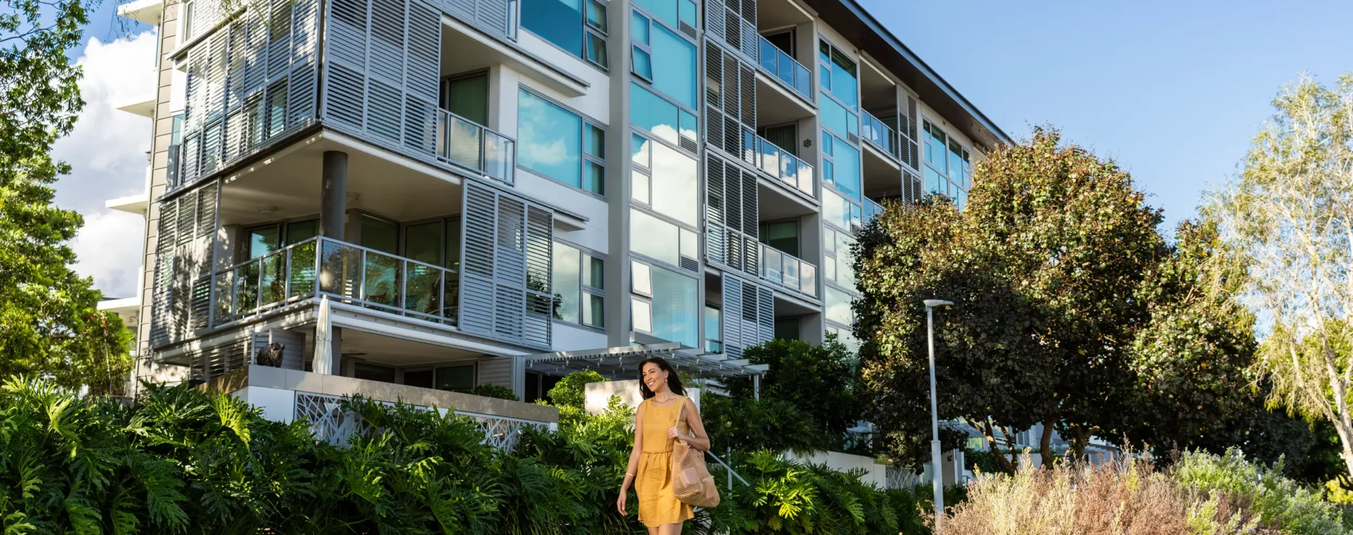 Individual walking by apartments at Northshore Hamilton