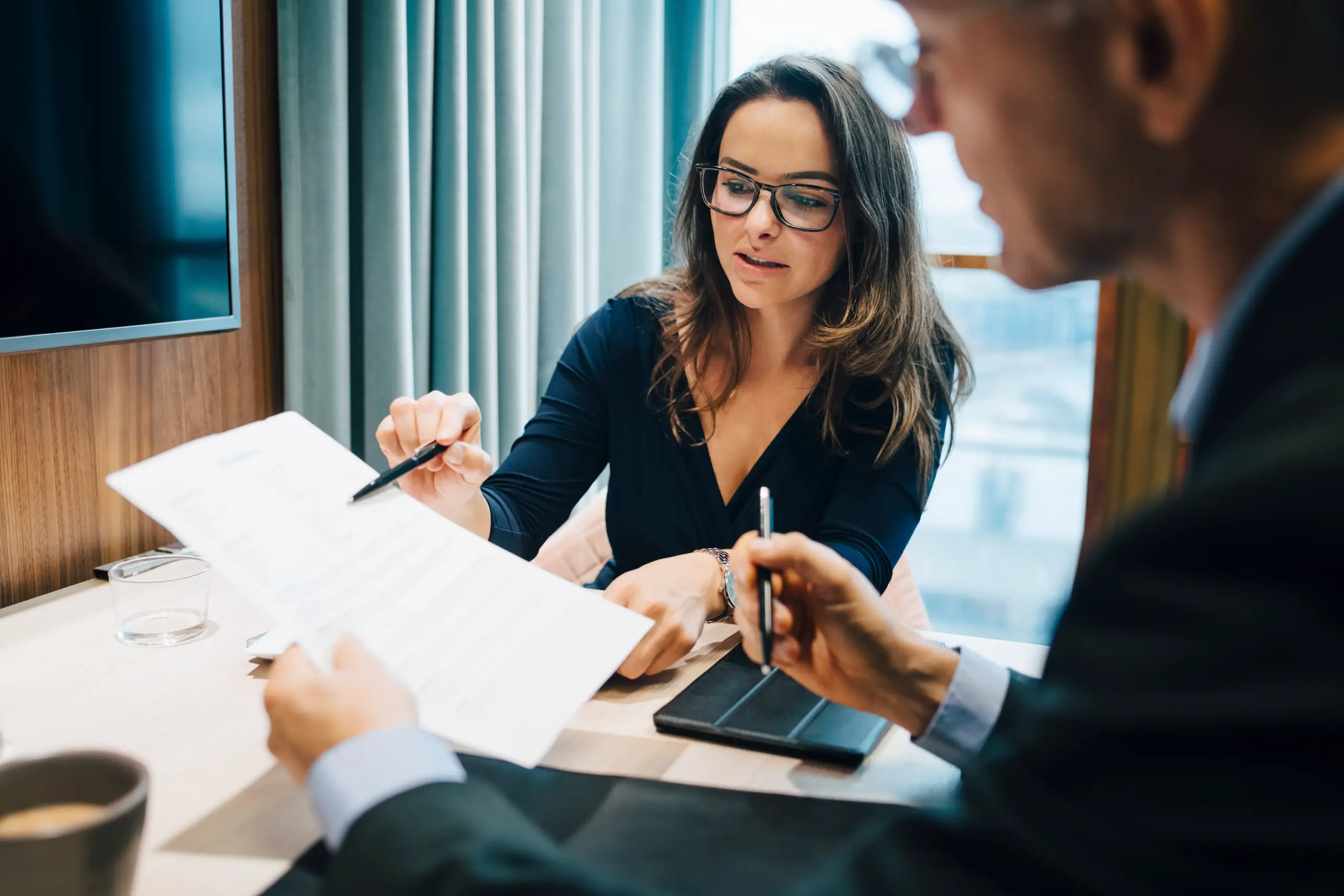 Two people meeting and interacting with documents