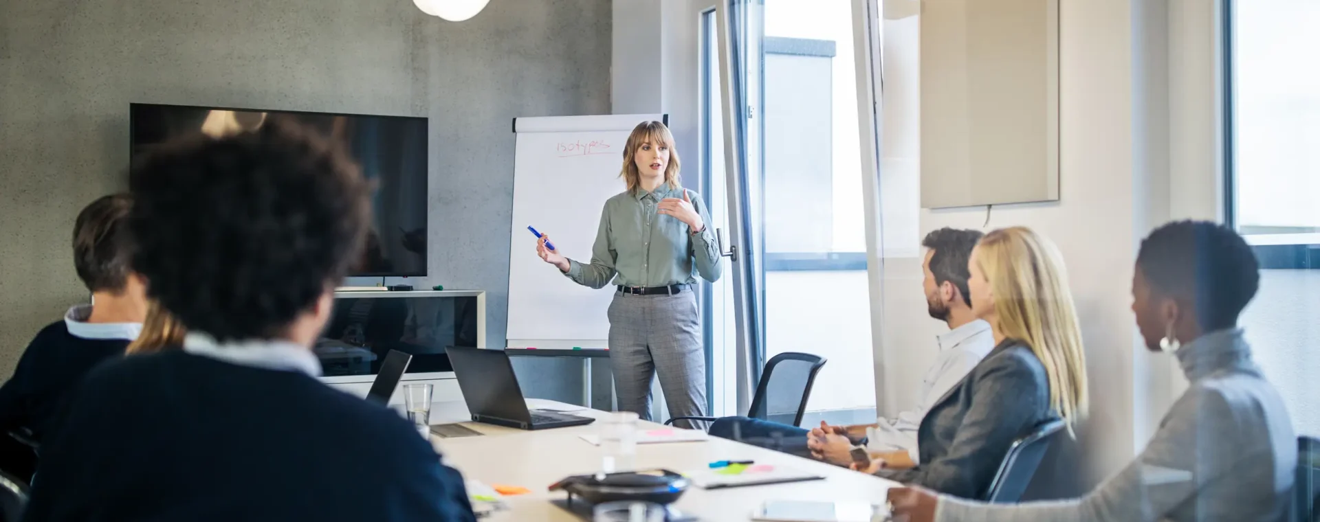 Group meeting in a conference room with an individual presenting