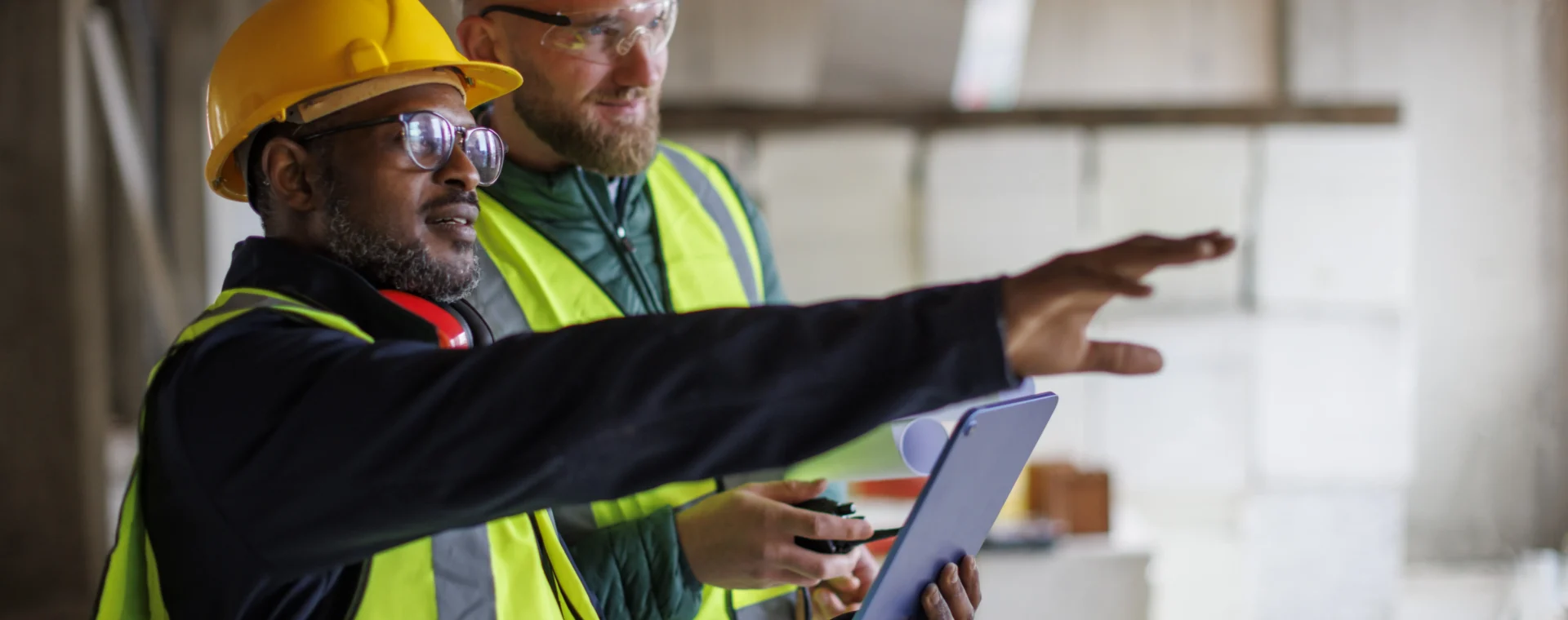 Two People in hi-vis assessing a site