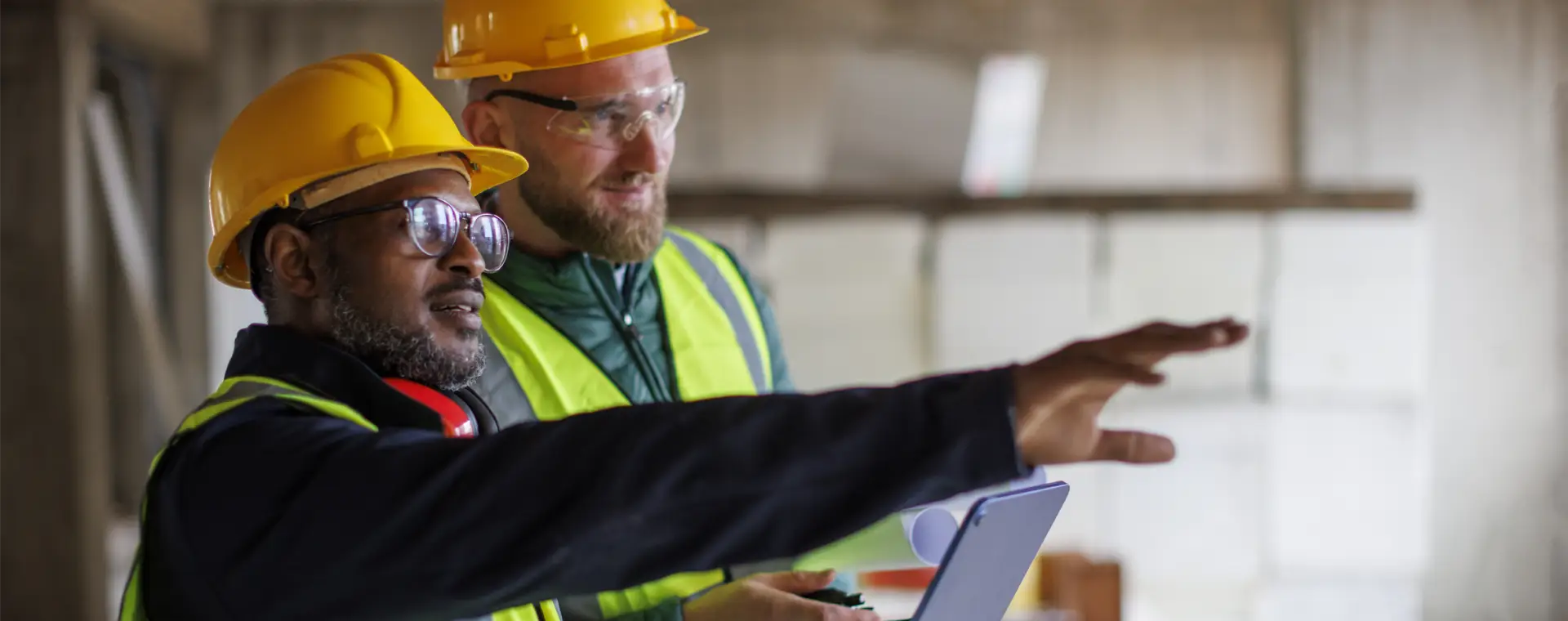 Two People in hi-vis assessing a site