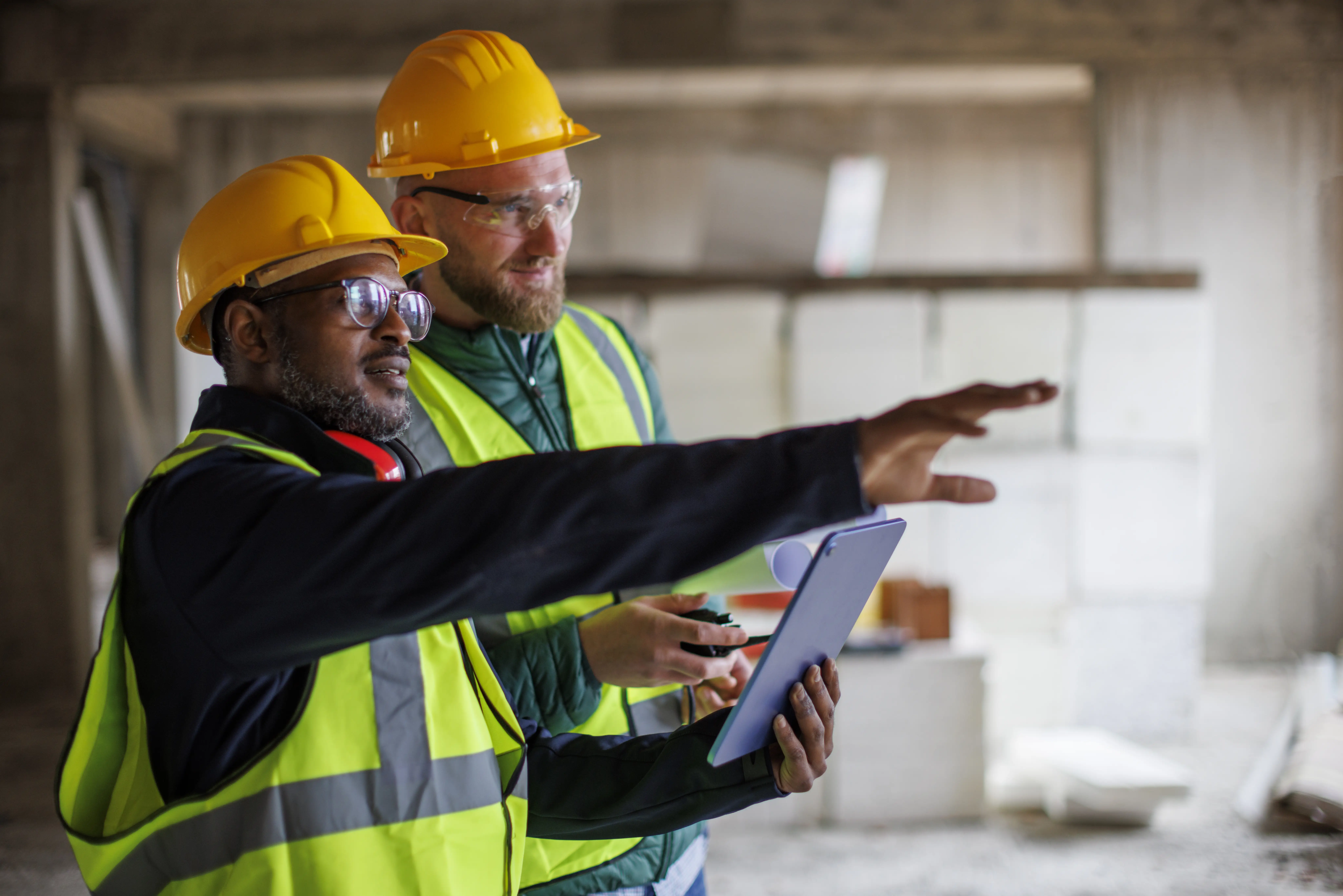 Two People in hi-vis assessing a site